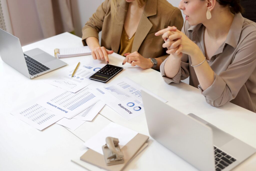 Team members reviewing business reports and data analysis related to ISO 14001 certification and compliance.